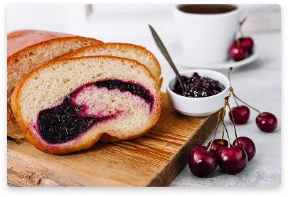 Swiss roll cake filled with sweet jam and dusted with powdered sugar