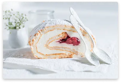 Light sponge cake roll filled with creamy vanilla filling