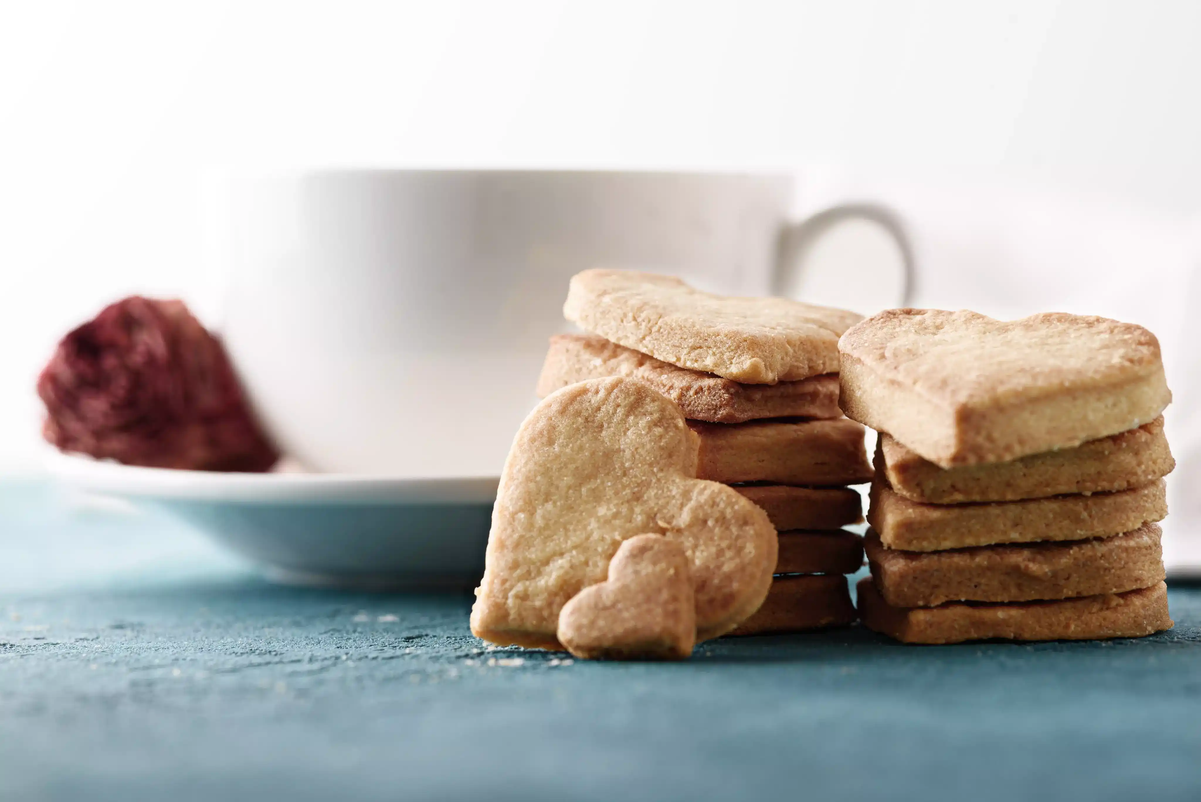 Classic buttery shortbread cookies in various shapes, some with jam filling or chocolate drizzle